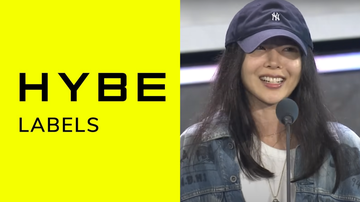 Min Hee Jin, CEO da ADOR, e logo da HYBE - Reprodução/YouTube /걸스 온 파이어 X KPOP JAMM/ HYBE